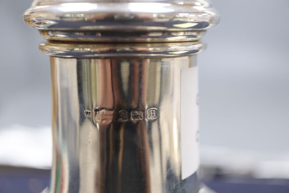 A silver vase shape sugar shaker, with pierced domed cover, ribbed finial on circular base, Birmingham 1932, 7.6oz., height 23cm